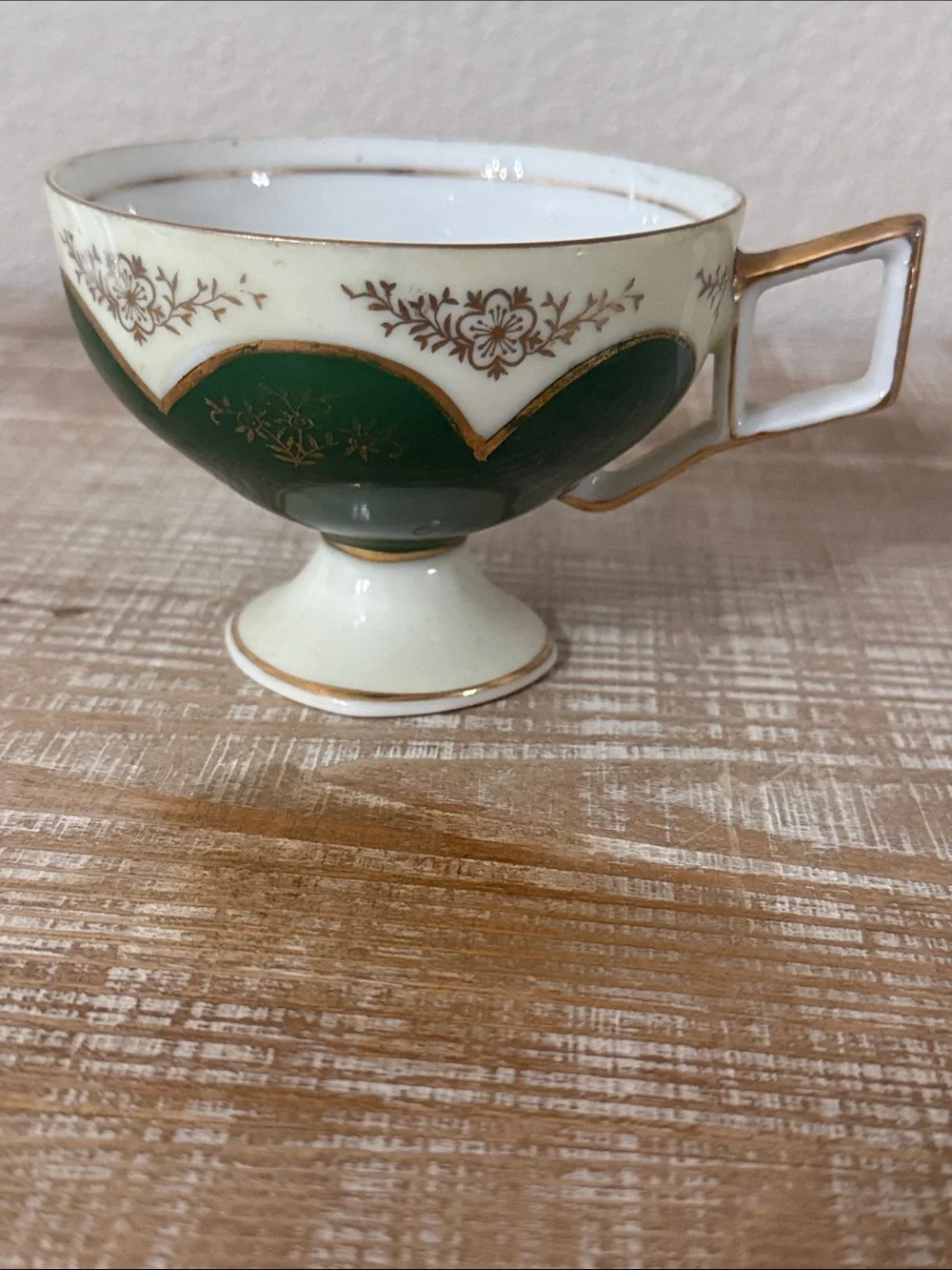 Vintage Japanese green and gold reticulated teacup, and pierced saucer.